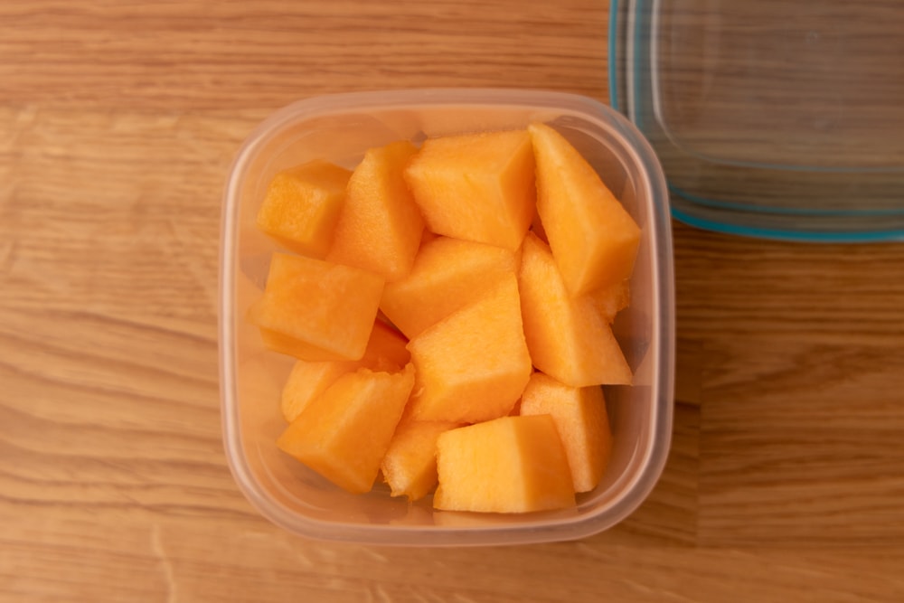 Diced melon in a plastic container