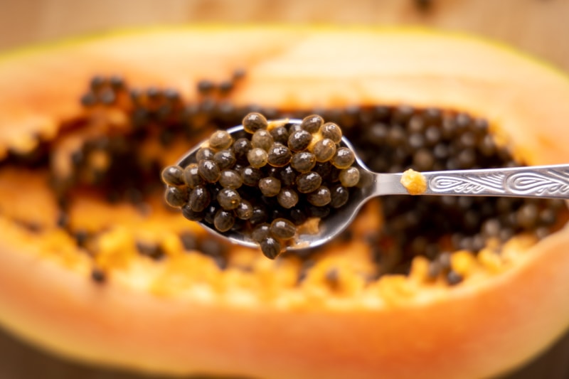 Papaya removing seeds with a spoon