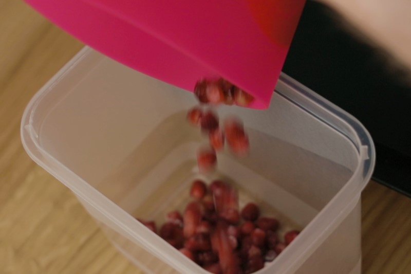 Pouring frozen pomegranate seeds