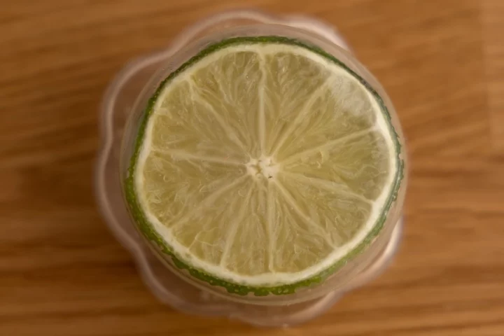 Lime cut in half in a silicone food container