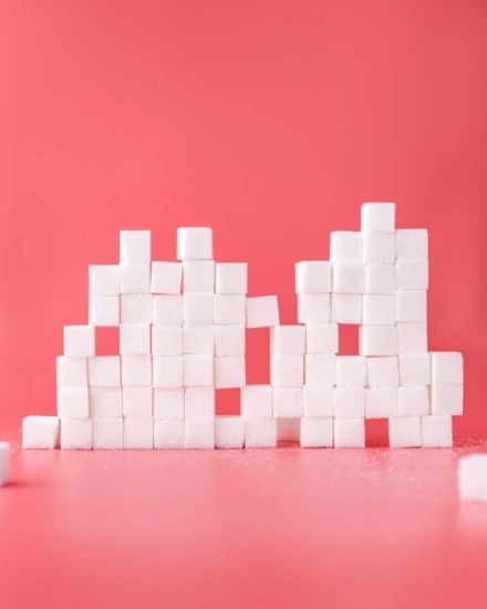 Sugar cubes on red background