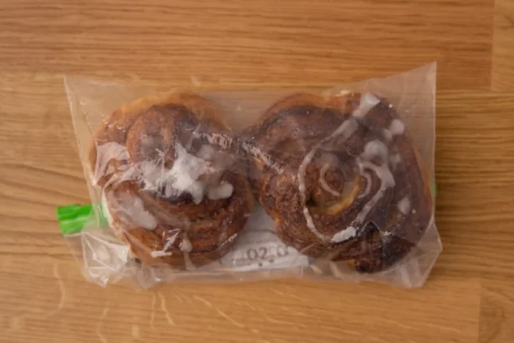 Two cinnamon buns in a freezer bag