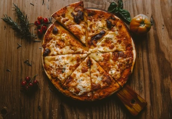Pizza in a wooden pizza pan