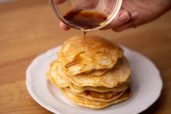 Pour maple syrup over the pancakes